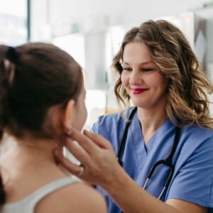 Doctor,Examining,Lymp,Nodes,On,Neck,Of,The,Young,Girl.